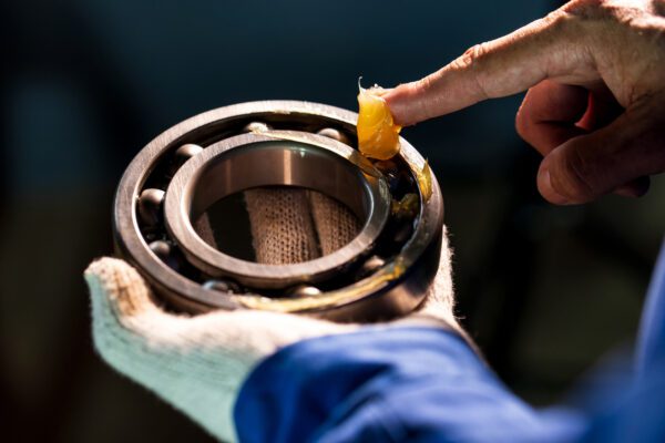Close Up Of Lubricant Grease In Hand Mechanic For Putting Into Ball Bearing In The Industrial Factory, Mechanic Industrial Concept